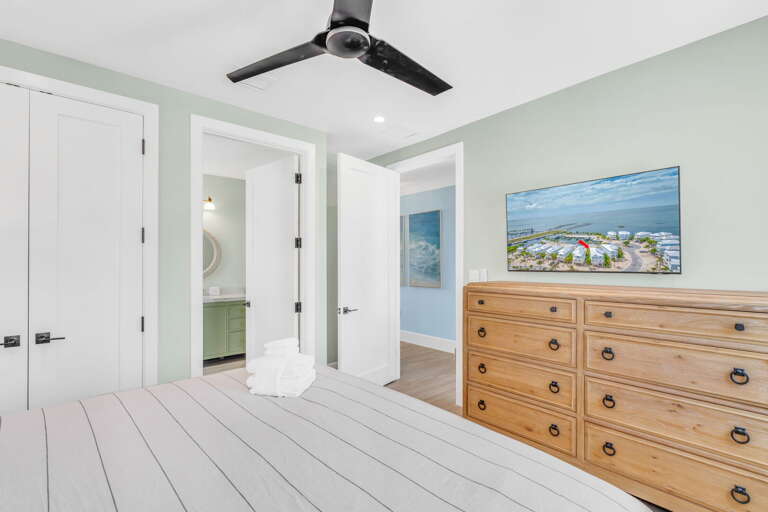 Enjoy privacy and modern amenities in this elegant king bedroom with ensuite bathroom and smart TV, ideal for relaxing stays in Marathon's luxury waterfront rental.