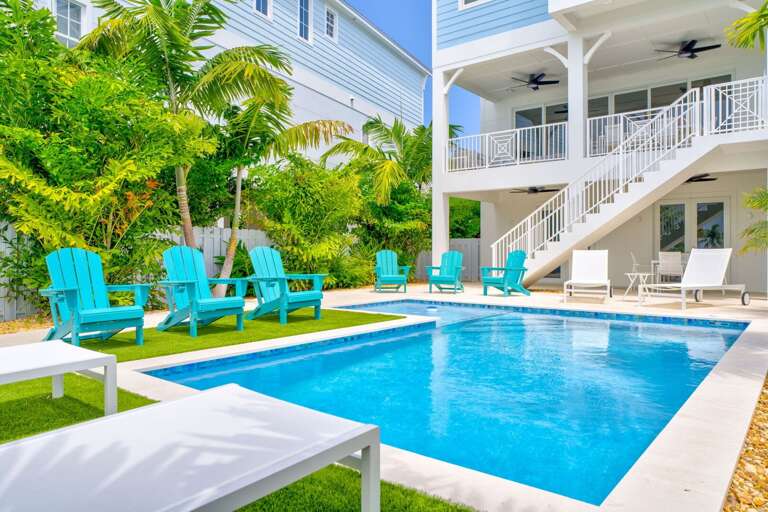 Enjoy seamless indoor-outdoor living with this waterfront pool area and direct dock access in the Florida Keys.