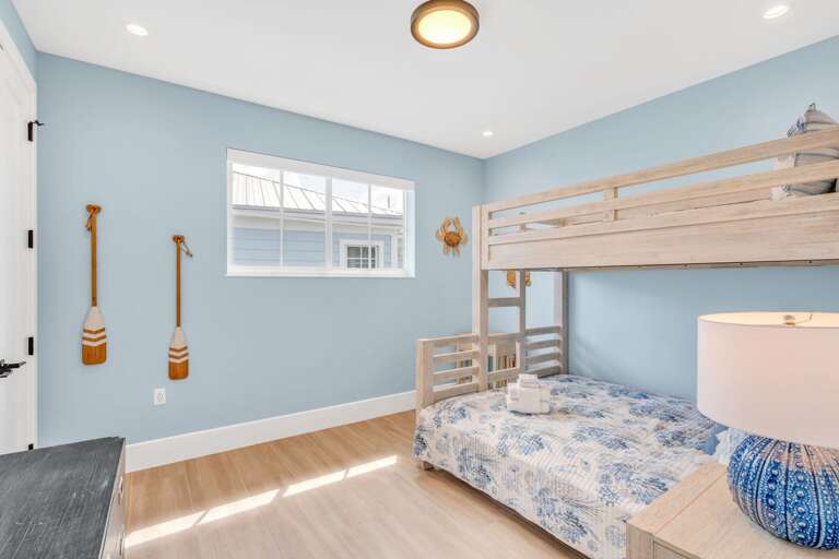 Family-friendly bunk bedroom on the third floor featuring a smart TV, ideal for kids and groups in this spacious Florida Keys waterfront rental.