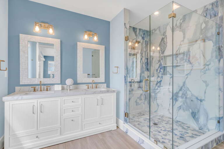 This third-level master ensuite features a spacious walk-in shower, double vanity, and premium finishes, the perfect spa-like escape in your Florida Keys vacation home.