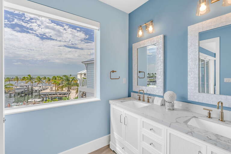 Relax in this elegant master bathroom with modern design and serene ambiance, part of a top-tier Gulf-front vacation rental in Marathon, Florida.