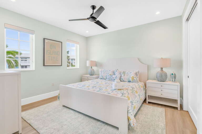 Relax in this spacious third-level king bedroom featuring a private ensuite bathroom and smart TV, offering comfort and modern amenities in your Florida Keys luxury rental.