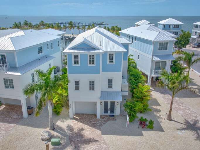 This stunning 5-bedroom vacation home features sleek design, water views from every level, and top-tier amenities throughout.