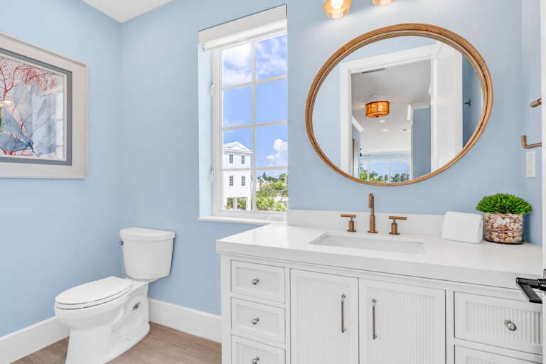 This stylish second-level hall bathroom in our Marathon vacation rental offers modern finishes, full amenities, and easy access for guests in this luxury Florida Keys home.