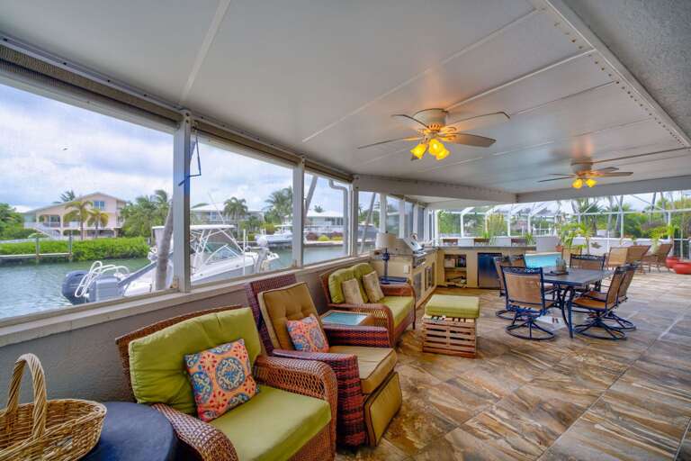 Comfortable outdoor lounge with TV and shaded seating area, ideal for relaxing poolside at a Marathon vacation home. Comfortable outdoor lounge with TV and shaded seating area, ideal for relaxing poolside at a Marathon vacation home.