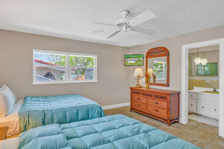 Comfortable waterfront vacation rental bedroom with two queen beds, smart TV, and modern amenities in the Florida Keys. Comfortable waterfront vacation rental bedroom with two queen beds, smart TV, and modern amenities in the Florida Keys.