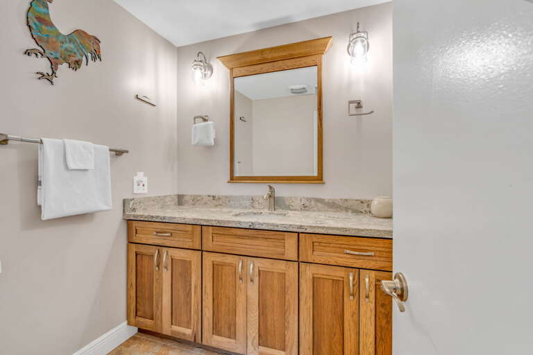 Convenient half bath with modern finishes, perfect for guests in a luxury Marathon Florida Keys vacation rental. Convenient half bath with modern finishes, perfect for guests in a luxury Marathon Florida Keys vacation rental.