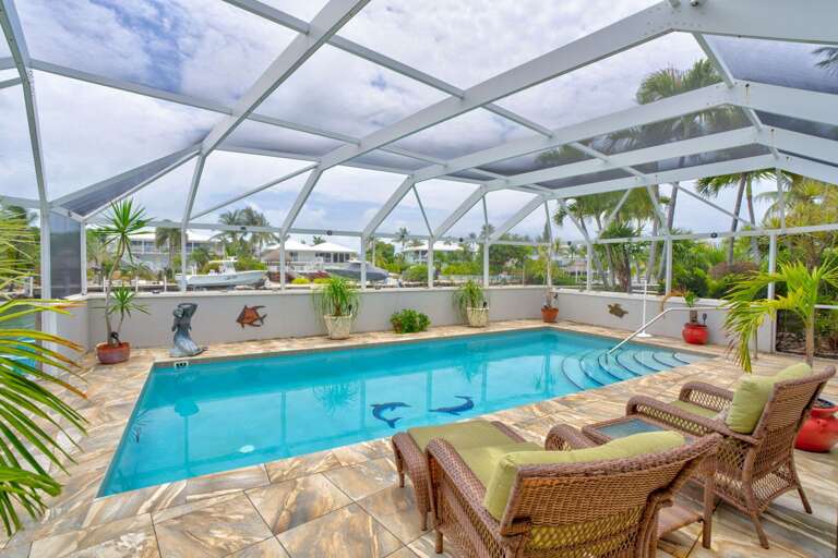 Crystal clear heated pool inside a screened enclosure, offering year-round enjoyment at this Marathon FL vacation rental. Crystal clear heated pool inside a screened enclosure, offering year-round enjoyment at this Marathon FL vacation rental.