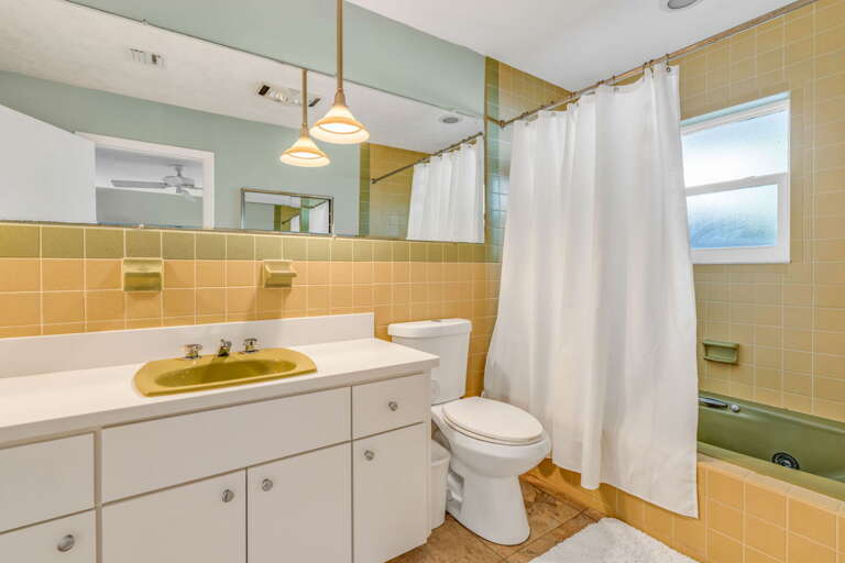 Guest ensuite bathroom with a jetted tub and shower combo, perfect for relaxing after a day in the Florida Keys. Guest ensuite bathroom with a jetted tub and shower combo, perfect for relaxing after a day in the Florida Keys.
