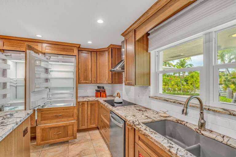 Modern coastal kitchen in a Marathon vacation rental featuring a built-in refrigerator and freezer, perfect for family gatherings. Modern coastal kitchen in a Marathon vacation rental featuring a built-in refrigerator and freezer, perfect for family gatherings.