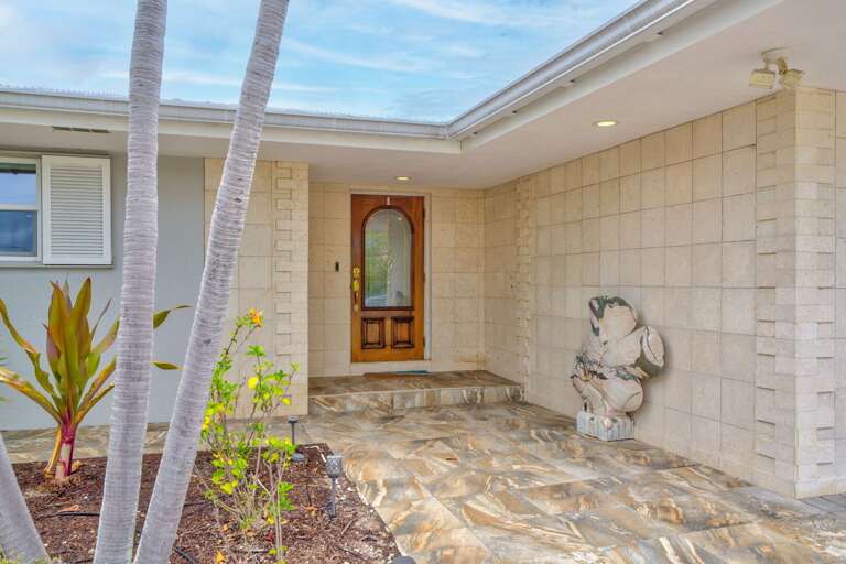 Welcoming exterior entryway with lush landscaping and coastal charm at this Florida Keys vacation home. Welcoming exterior entryway with lush landscaping and coastal charm at this Florida Keys vacation home.
