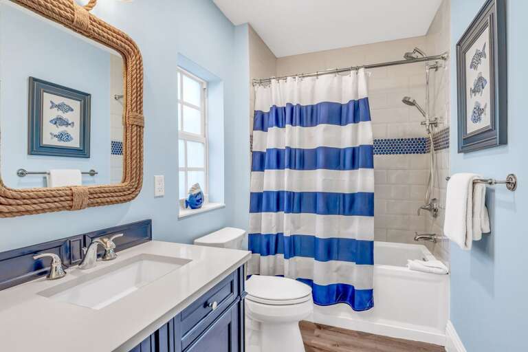 Bright and modern, this shared bathroom offers convenience and comfort for guests staying in bedrooms 4 and 5 of this Florida Keys vacation rental.
