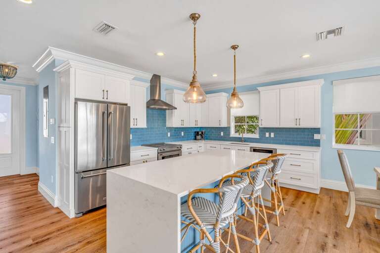 Enjoy the bright, airy kitchen at this oceanfront rental, complete with island seating for three and breathtaking water views for a luxury vacation experience.