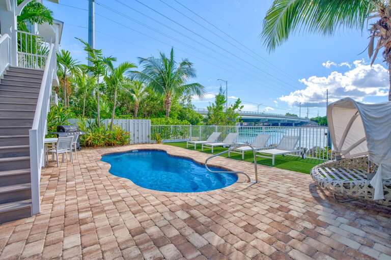 Enjoy leisure and comfort in this 10x22' pool featuring multiple seating ledges and direct views of the sparkling waters of Vaca Cut.