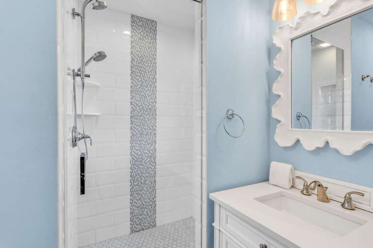 Enjoy a modern ensuite with walk-in shower, sleek fixtures, and coastal-inspired finishes in this king guest bedroom of your Marathon FL vacation rental.