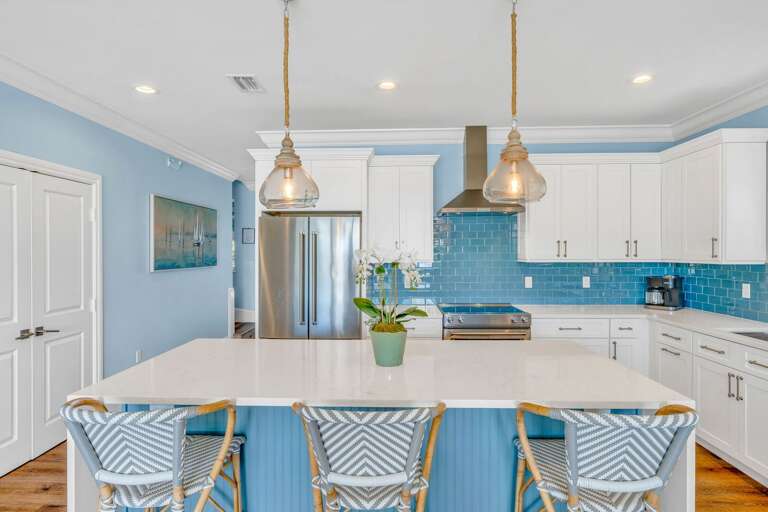 This fully equipped kitchen in a Florida Keys vacation rental offers high-end appliances, panoramic water vistas, and seamless access to the dining and living areas.