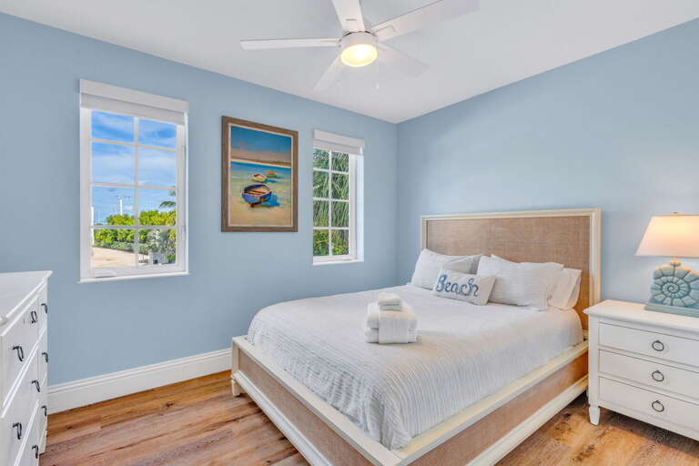 Ideal for families or couples, this second-level bedroom in a Marathon FL rental features a queen bed, Smart TV, and blackout shades for restful sleep.
