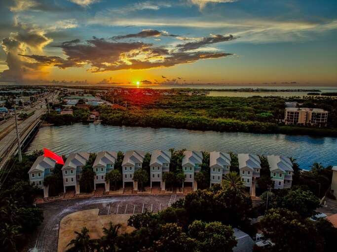 Modern coastal architecture and lush landscaping complement the private waterfront setting of this Florida Keys home.
