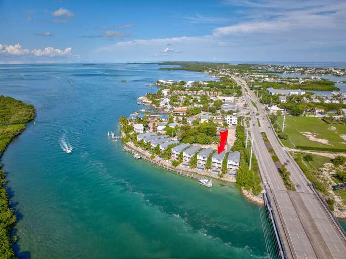 Relax in luxury with a heated pool, hot tub, and multiple outdoor seating areas overlooking the sparkling waters of Vaca Cut.