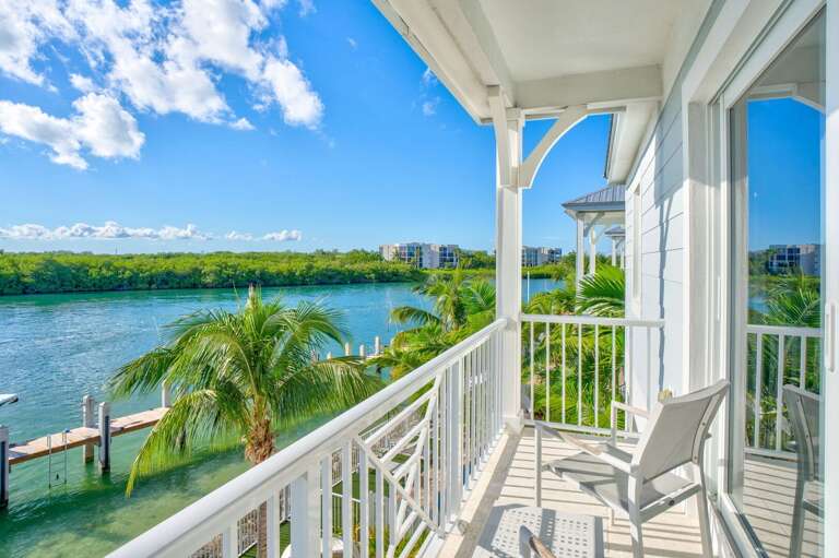 Step onto your private master balcony with seating and breathtaking panoramic Gulf and Atlantic views, ideal for morning coffee or sunset relaxation in the Florida Keys.