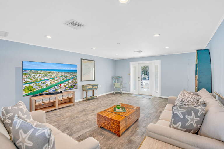 Coastal-inspired living area with plush sofas, Smart TV, and tropical decor in Key Colony Beach Florida Keys vacation home. Coastal-inspired living area with plush sofas, Smart TV, and tropical decor in Key Colony Beach Florida Keys vacation home.