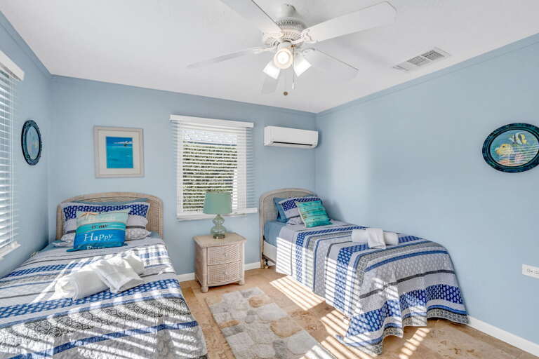 Coastal-style twin room featuring two beds and bright island design in Key Colony Beach FL vacation rental.