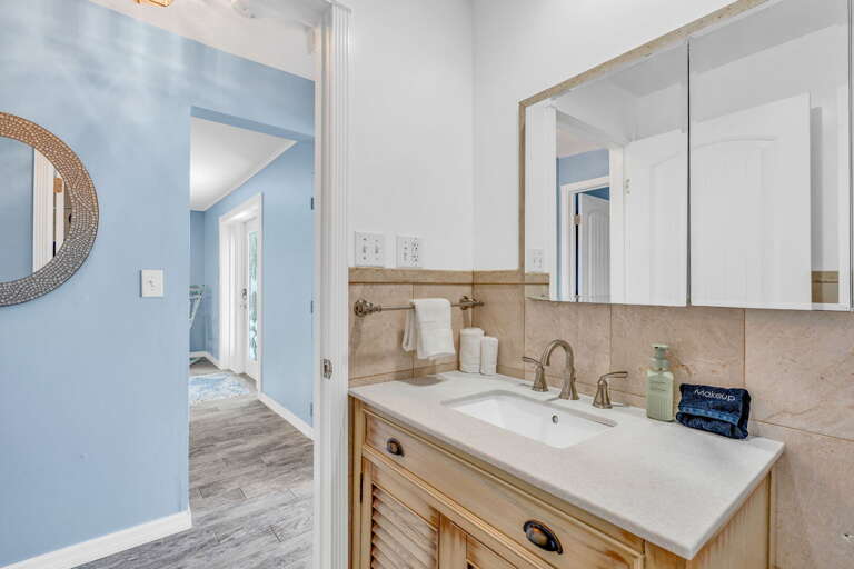 Family-friendly hall bathroom with tropical decor and modern fixtures in Key Colony Beach Florida Keys vacation rental.