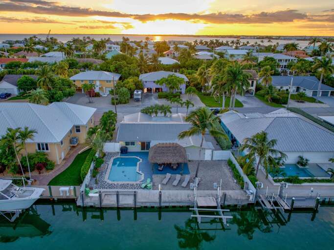 Nighttime view of private pool with lighting and waterfront at Key Colony Beach Florida Keys luxury vacation rental. Nighttime view of private pool with lighting and waterfront at Key Colony Beach Florida Keys luxury vacation rental.