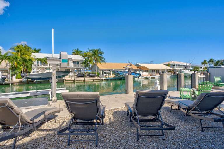 Poolside loungers and outdoor seating at oceanfront Key Colony Beach Florida Keys vacation rental. Poolside loungers and outdoor seating at oceanfront Key Colony Beach Florida Keys vacation rental.