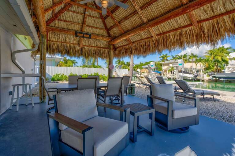 Relaxing tiki hut seating overlooking the water at Key Colony Beach Florida Keys vacation rental. Relaxing tiki hut seating overlooking the water at Key Colony Beach Florida Keys vacation rental.