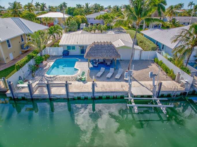 Waterfront dock with boat lift at luxury Florida Keys vacation rental home. Waterfront dock with boat lift at luxury Florida Keys vacation rental home.