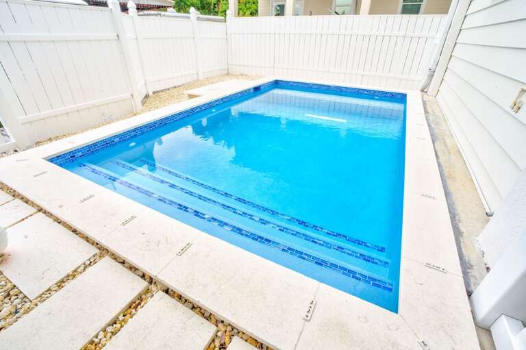 Dive into paradise with a secluded pool steps from the boat dock.