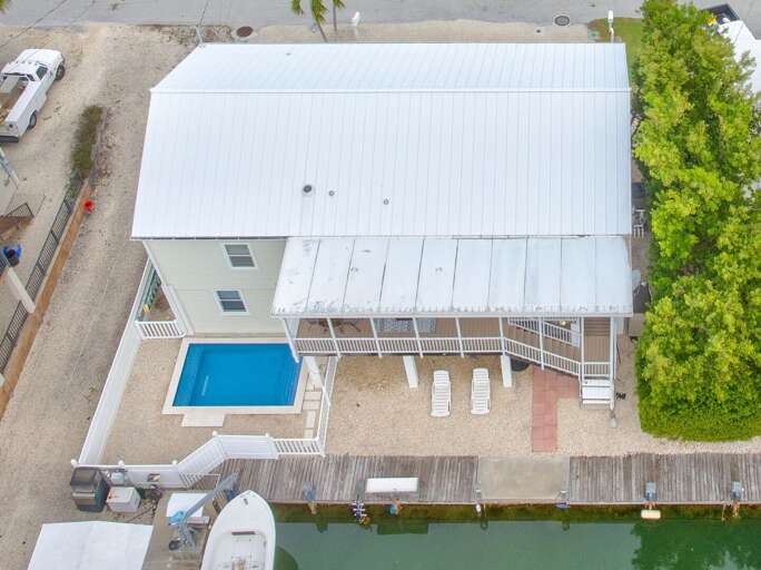 Elevated view highlighting a private dock home on a 6' deep-water canal with direct access to the Atlantic Ocean, ideal for boating enthusiasts.