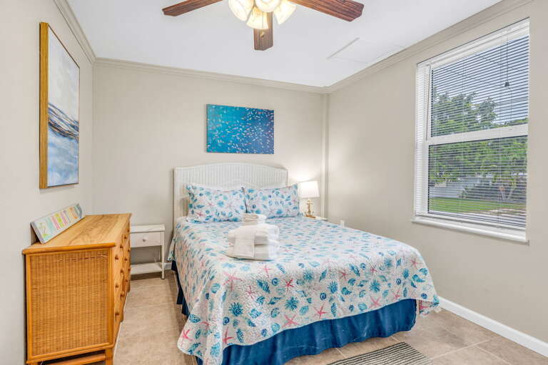 A fully private suite with closed-door bedroom, modern bath, and a comfortable living area overlooking the tropical canal.