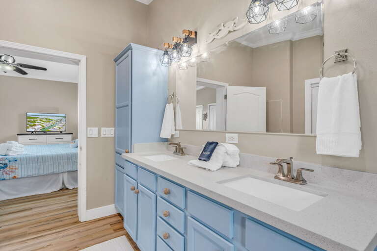 Light, bright, and modern, this luxury bath complements the master suite with spa-like amenities and fresh Florida Keys décor.