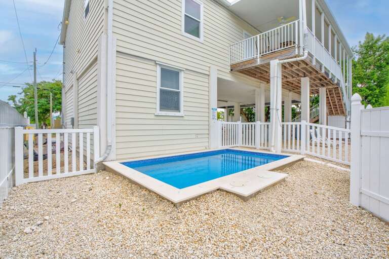 Outdoor oasis offering swimming, sunbathing, and boating access.