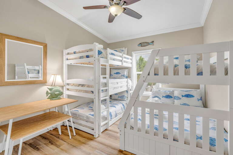 Perfect for kids and teens, this cozy bunk room offers comfortable sleeping space, coastal décor, and easy access to all the waterfront amenities in our Marathon FL pool home.