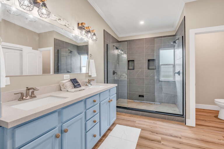 Spa-inspired primary bathroom featuring a walk-in shower, premium finishes, and private access from the master suite inside a canal-front Florida Keys rental.