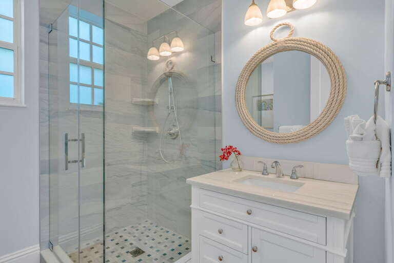 Beautifully designed guest bath with premium tile and bright coastal touches in a canal-front home with pool.