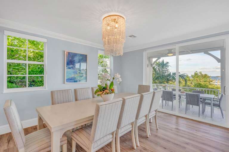 Bright dining space with seating for the whole group and views of the gulf and pool in this upscale Florida Keys rental.
