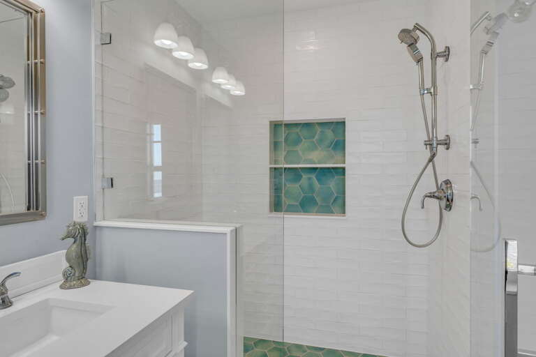 Indulge in a serene spa-inspired master bathroom featuring a spacious walk-in shower, premium tile