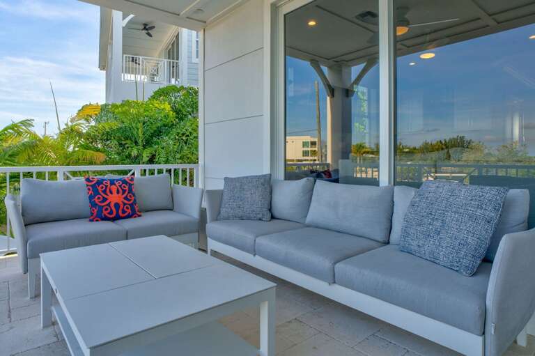 Relax on a spacious waterfront balcony designed for outdoor meals, morning coffee, and taking in the refreshing Florida Keys breeze.