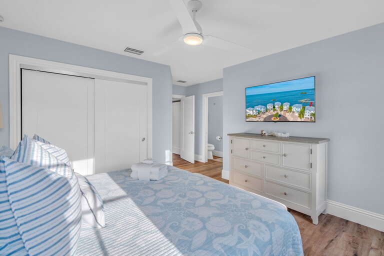 Spacious king-size bedroom featuring a private ensuite bath, premium linens, and coastal-inspired