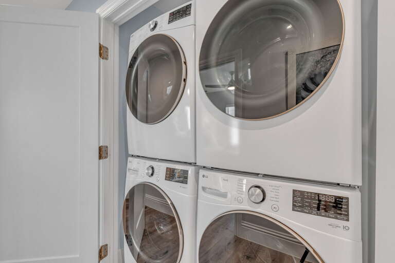 Two washer and dryer units positioned for easy access near sleeping areas, enhancing comfort and convenience in this high-end Florida Keys vacation rental with pool and community dock.