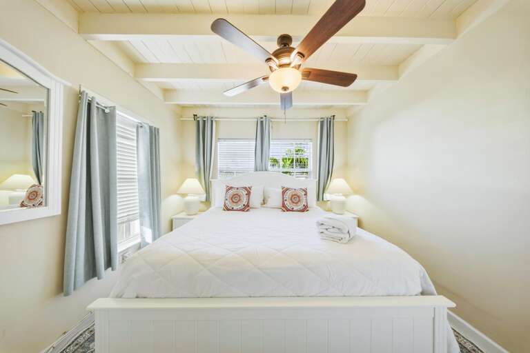 Comfortable king bedroom in a Marathon Florida Keys canal-front vacation rental home, ideal for guests seeking privacy and comfort.