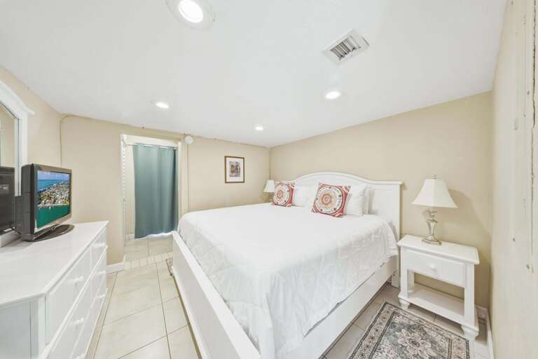 Elegant king bedroom in a Florida Keys waterfront vacation rental designed for relaxation and a comfortable stay.
