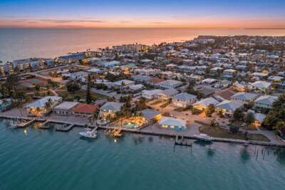 Experience breathtaking Florida Keys sunsets from the outdoor patio of this Marathon FL canal-front vacation rental with pool and tropical ambiance.