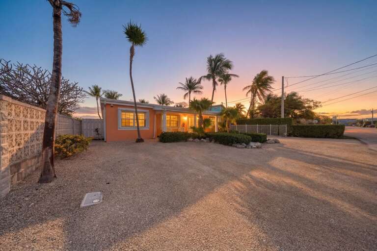 Relax and unwind as the sun sets over the canal at this Marathon Florida Keys vacation rental featuring a private pool and outdoor oasis.
