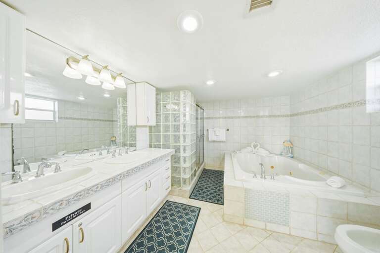 Relaxing master bathroom in a Marathon Florida Keys waterfront vacation rental featuring a luxurious jetted soaking tub.