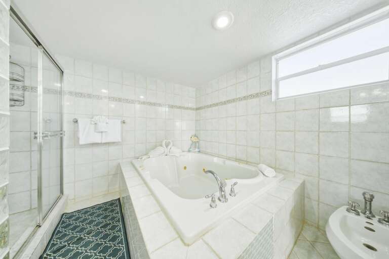 Upscale master bathroom featuring a relaxing jetted tub in a luxury waterfront Marathon FL vacation home.